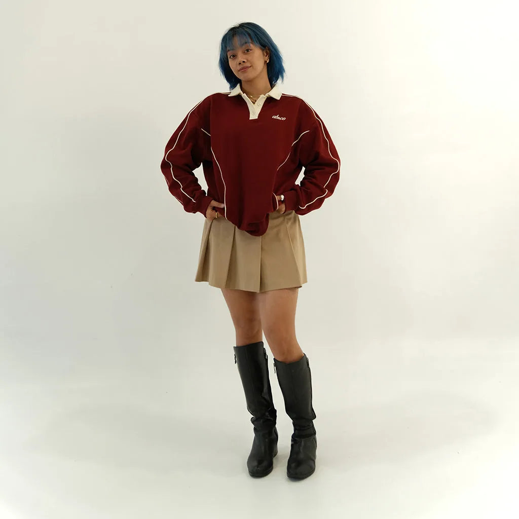 Female model in pomegranate red After Hours polo, front