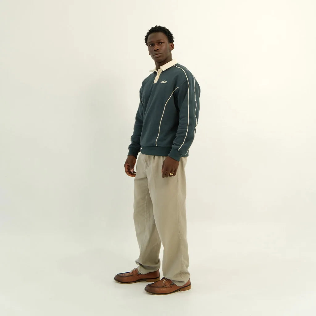 Male model in peacock teal After Hours polo, side