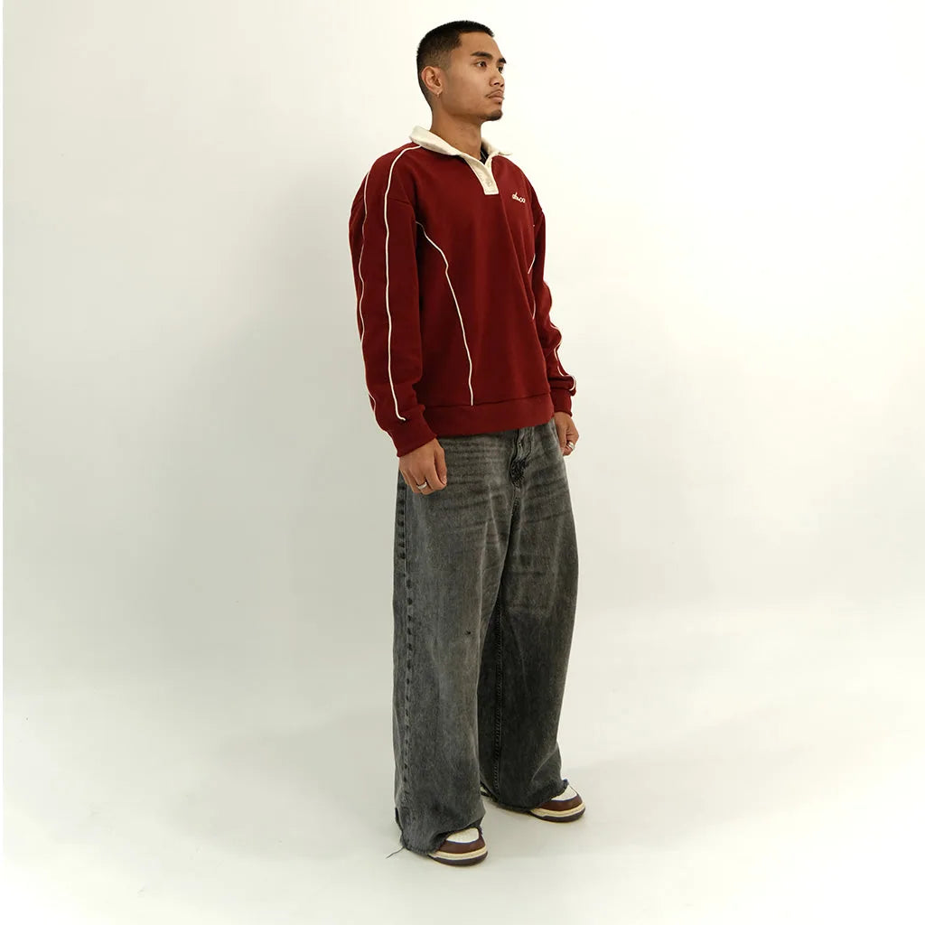 Male model in pomegranate red After Hours polo, side