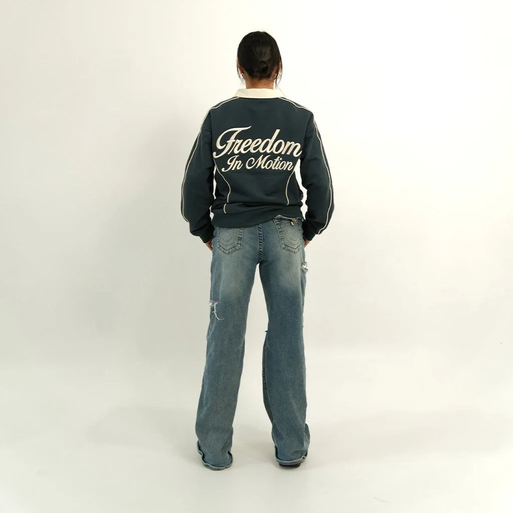 Peacock teal polo back with 'Freedom In Motion', on model