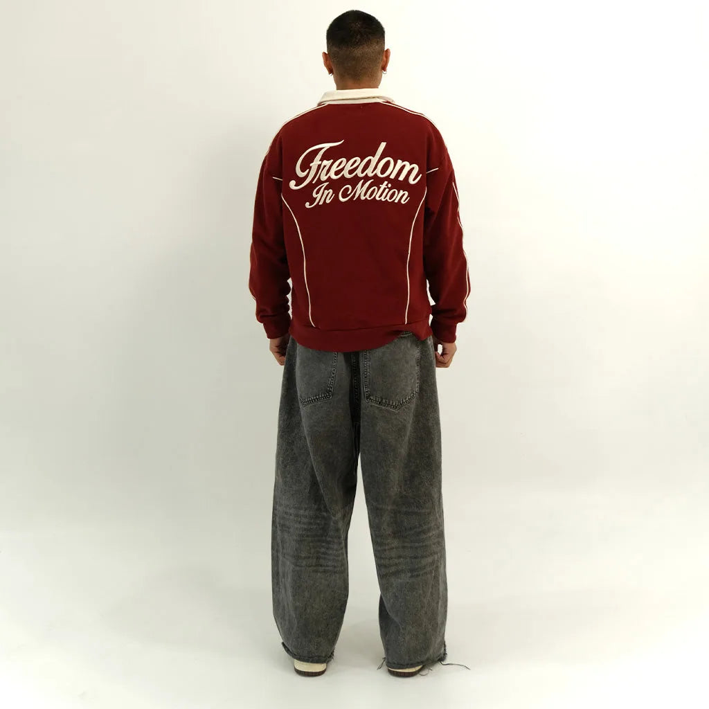 Pomegranate red polo back, 'Freedom In Motion' embroidery, on model