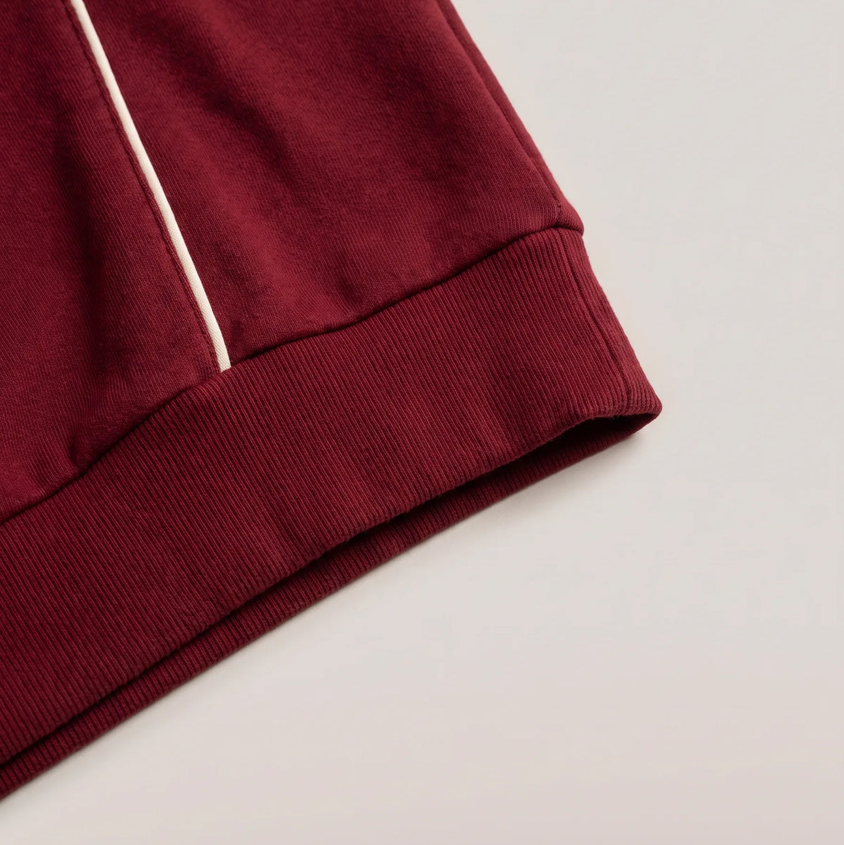Ribbed hem and cuff with cream piping, pomegranate red polo