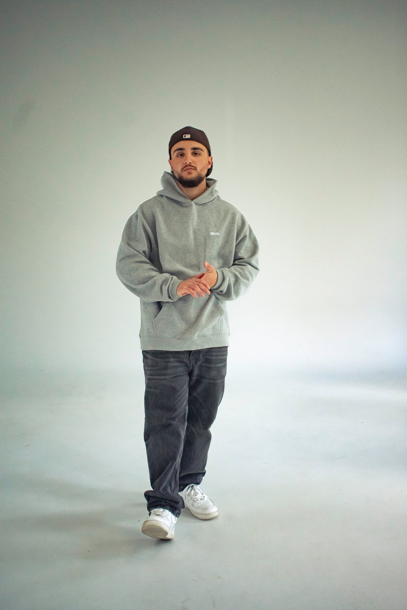 Heavyweight oversized hoodie in Grey with dropped shoulders, double-layer hood, and ribbed cuffs, designed for streetwear and everyday comfort.