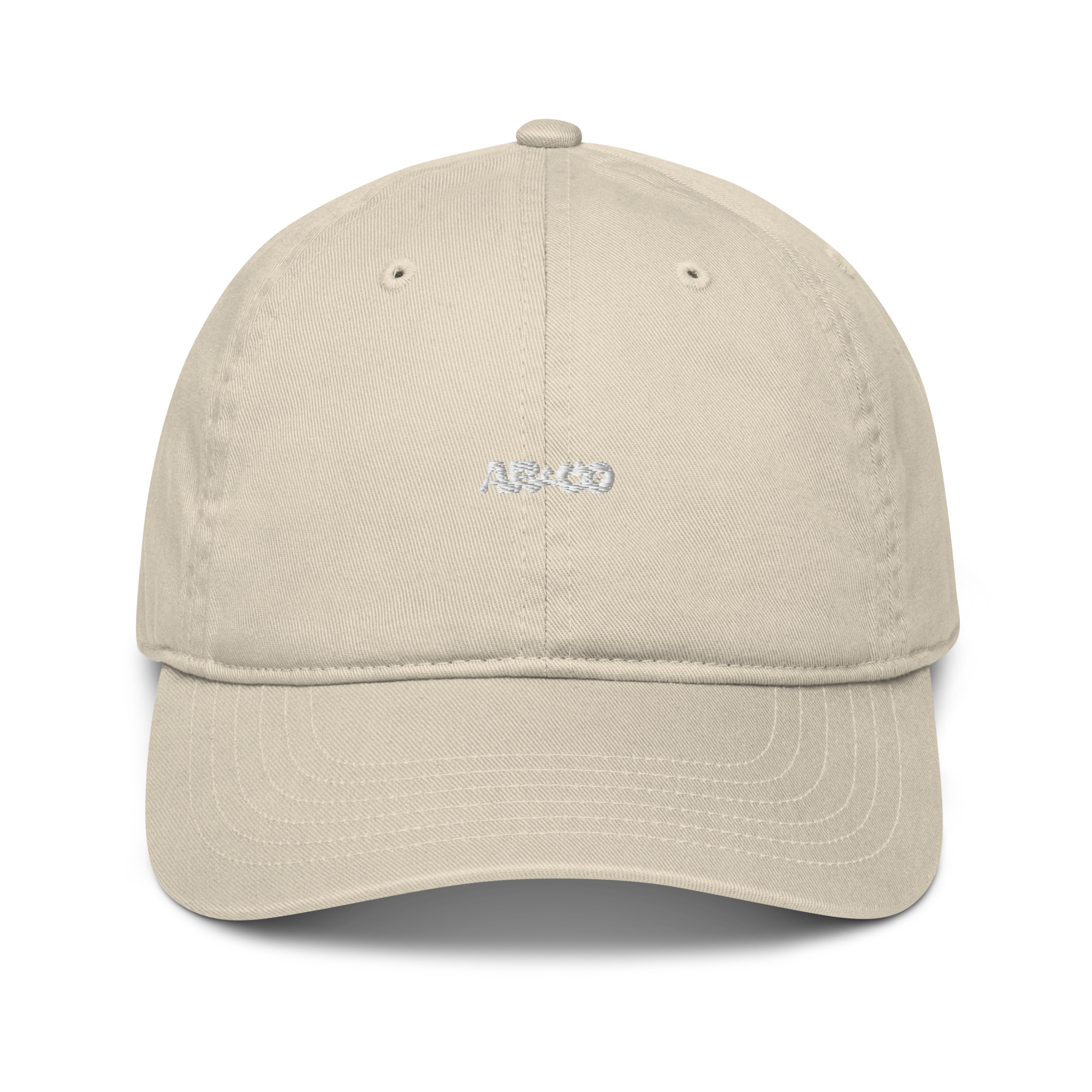 Organic cotton dad hat in Beige with embroidered logo, curved brim, and adjustable strap for a relaxed streetwear fit.