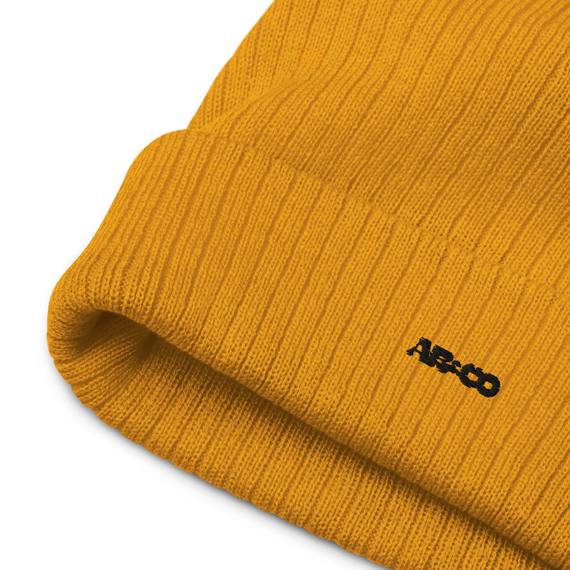 “Ribbed knit beanie in Mustard with embroidered logo, soft stretch fit, designed for warmth and everyday streetwear.