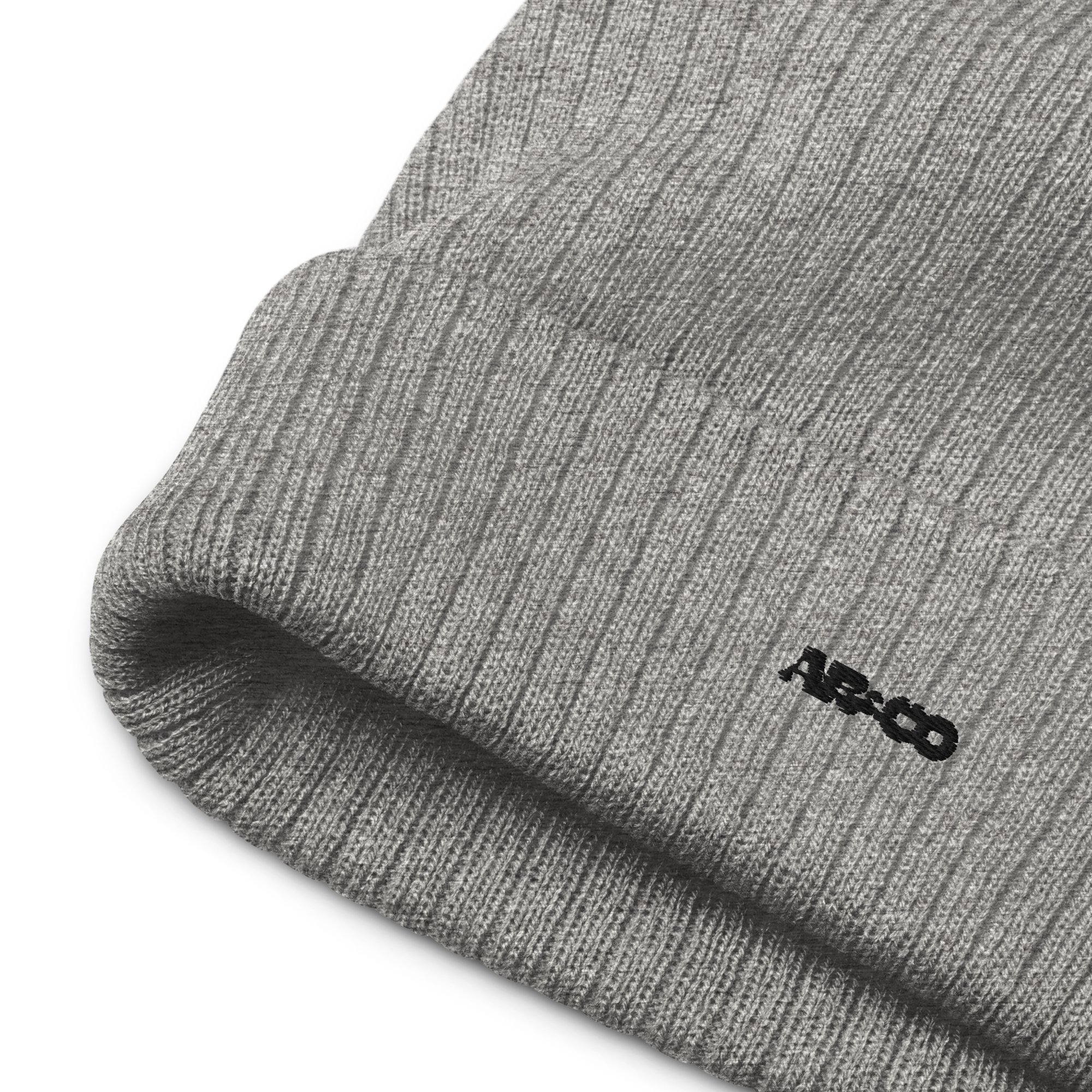 Ribbed knit beanie in Black with embroidered logo, soft stretch fit, designed for warmth and everyday streetwear.