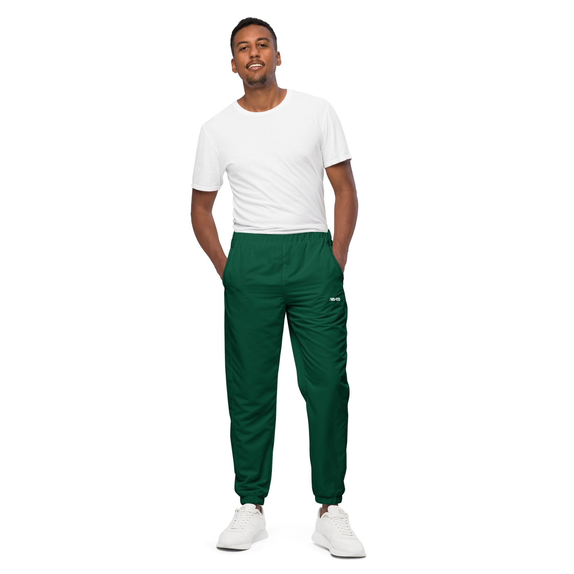 Unisex track pants in Green with elastic waistband, tapered leg, and side pockets. Relaxed streetwear style for everyday wear.