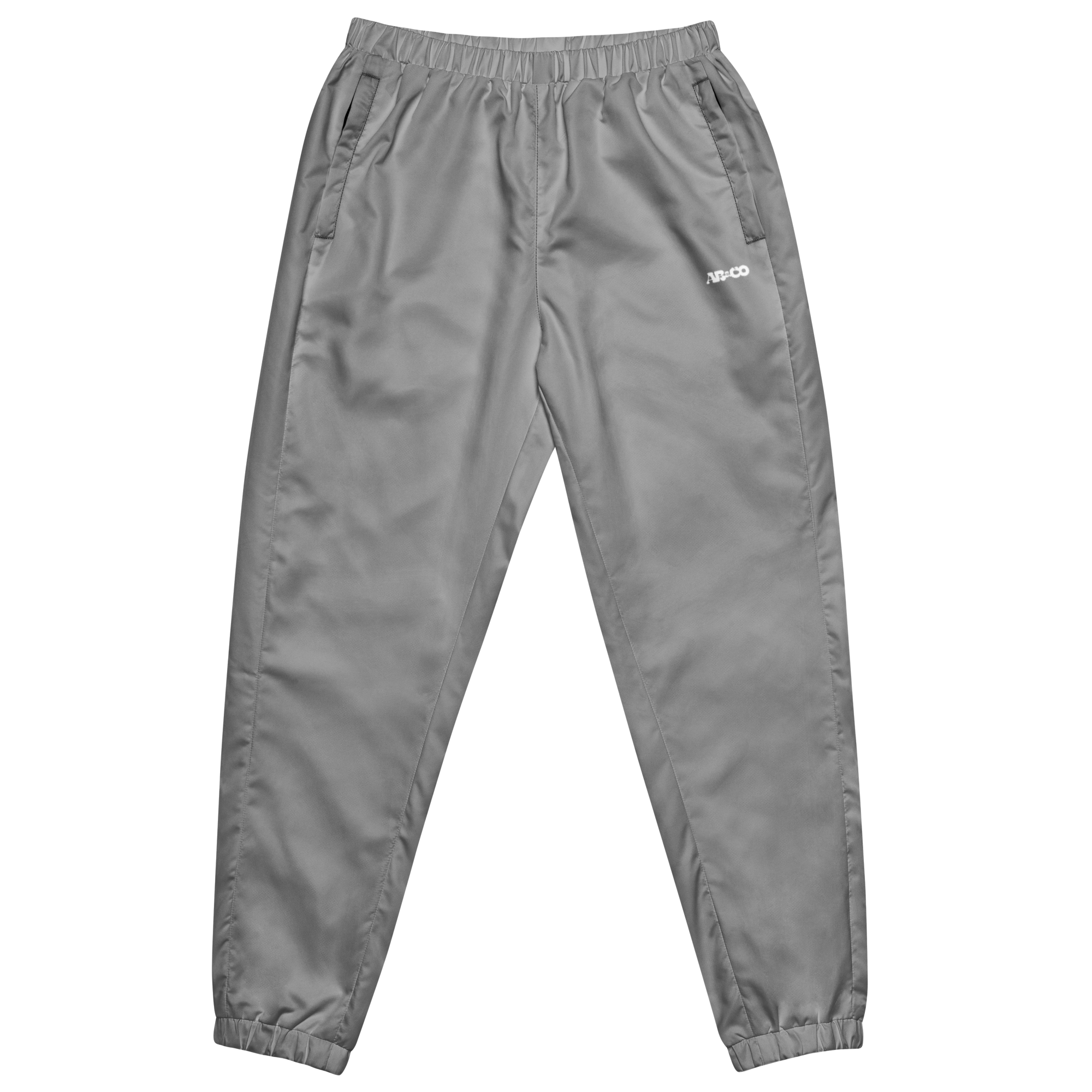 Unisex track pants in Grey with elastic waistband, tapered leg, and side pockets. Comfortable fit for streetwear and casual wear.
