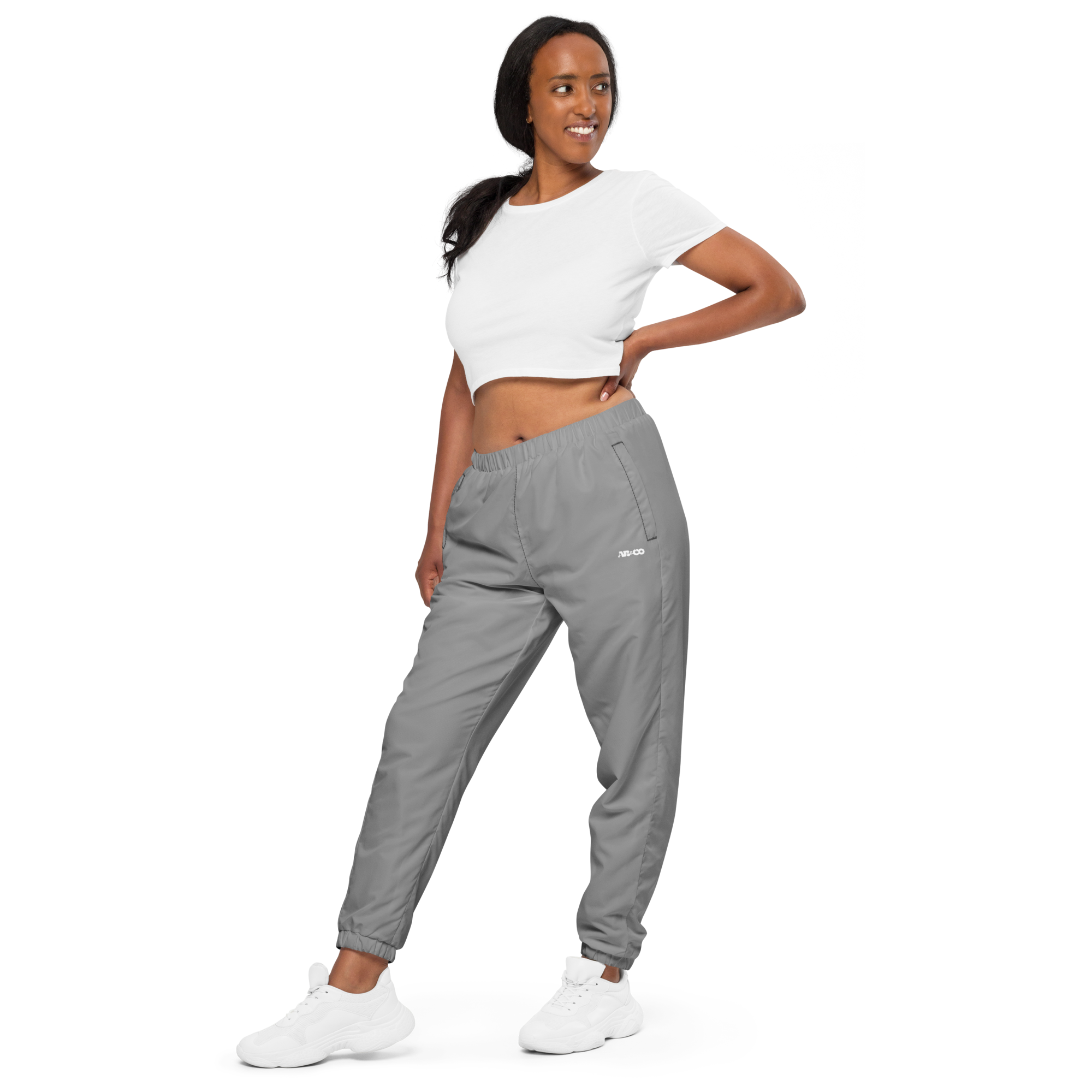Unisex track pants in Grey with elastic waistband, tapered leg, and side pockets. Comfortable fit for streetwear and casual wear.