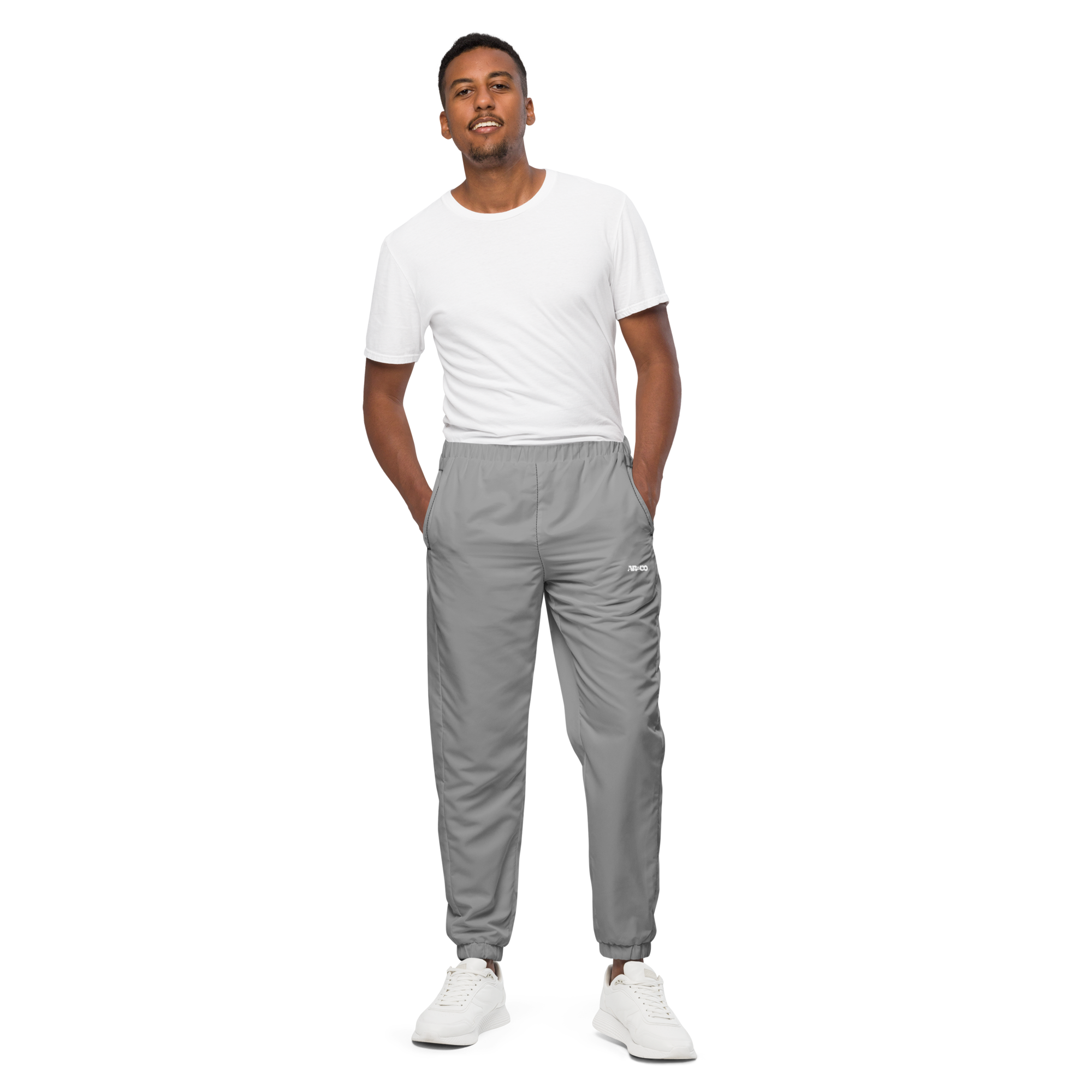 Unisex track pants in Grey with elastic waistband, tapered leg, and side pockets. Comfortable fit for streetwear and casual wear.