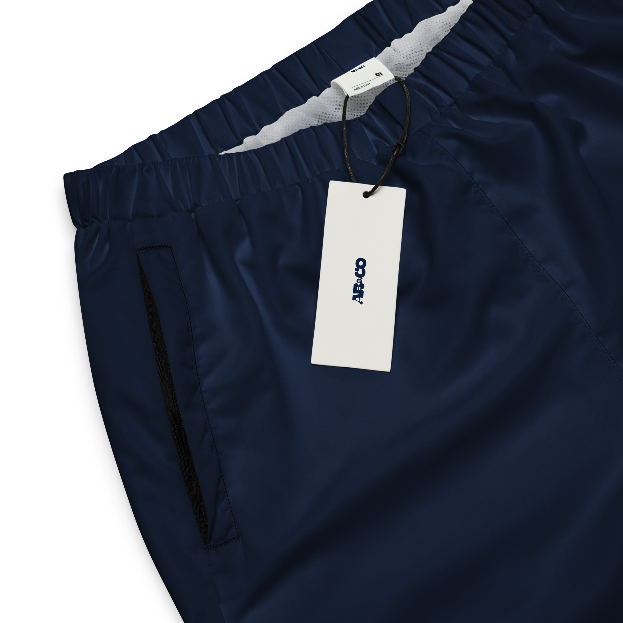 Unisex track pants in Navy Blue with elastic waistband, tapered leg, and side pockets. Relaxed streetwear style for everyday wear.