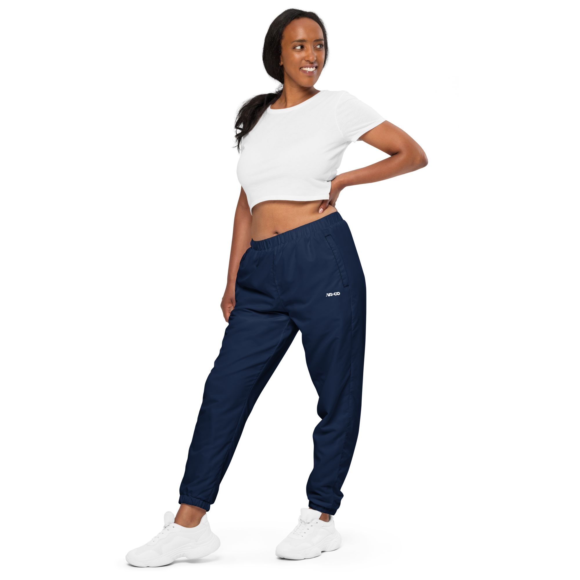Unisex track pants in Navy Blue with elastic waistband, tapered leg, and side pockets. Relaxed streetwear style for everyday wear